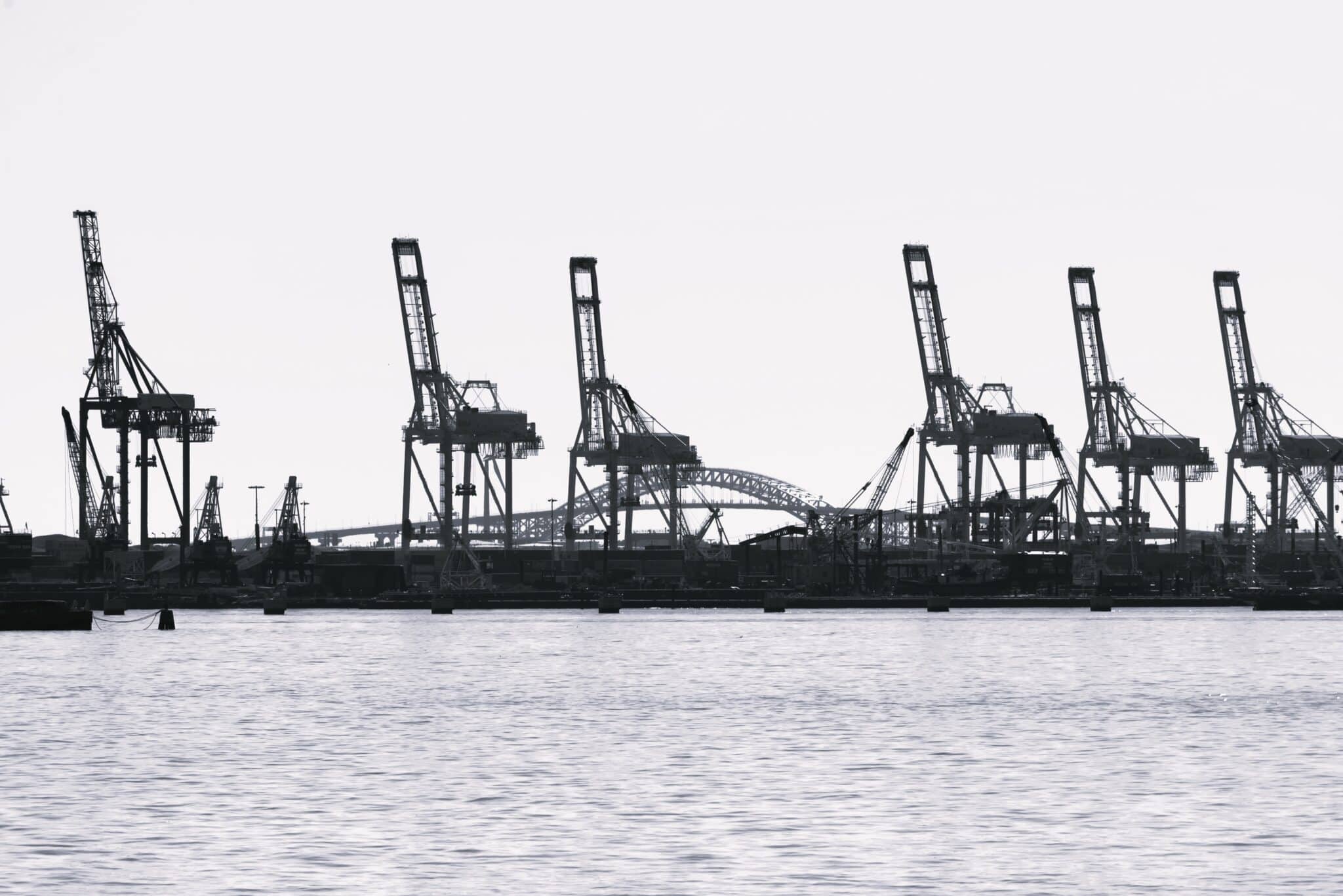 View of the seaport in New York at sunset, USA. Lots of cranes